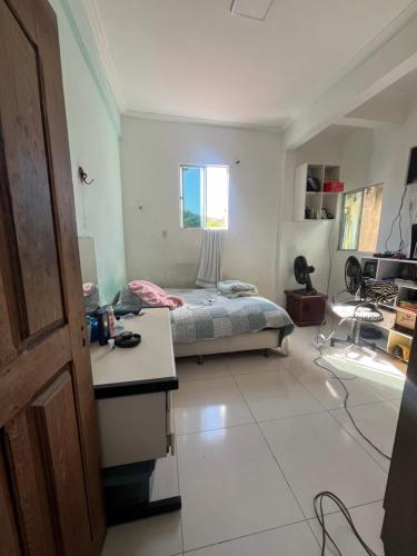 a bedroom with a bed and a desk in it at Casa Costa in Belém