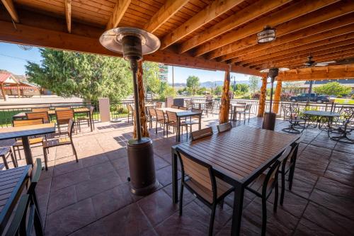 an outdoor patio with tables and chairs and a pole at Bryce Canyon Inn in Tropic