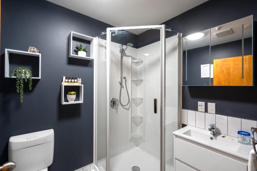 a bathroom with a shower and a toilet and a sink at Woodland Glen Lodge B&B in Hokitika