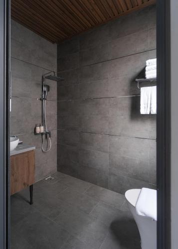 a bathroom with a shower and a toilet and a sink at Scenery Hotel DaLat in Da Lat