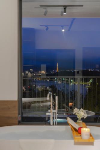 a room with a window with a view of a city at Scenery Hotel DaLat in Da Lat
