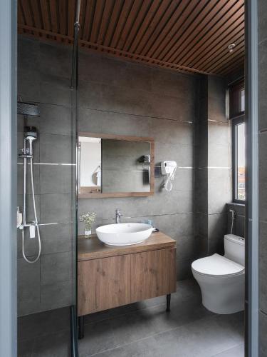 a bathroom with a sink and a toilet at Scenery Hotel DaLat in Da Lat