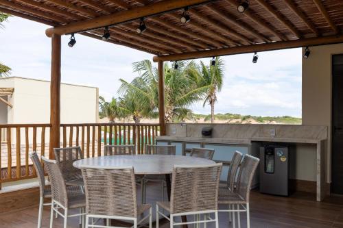 a patio with a table and chairs on a deck at Casa Fortim Eco Village in Fortim