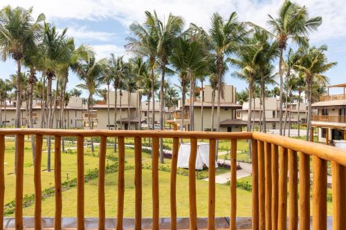 a view from the balcony of a resort with palm trees at Casa Fortim Eco Village in Fortim