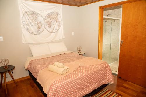 a bedroom with a bed with two towels on it at Villa da Serra - Casa 02 in São Bento do Sapucaí