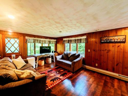 a living room with a couch and a television at Rustic 3 bedroom Cottage in The Western Maine Mountains in Waterford Flat