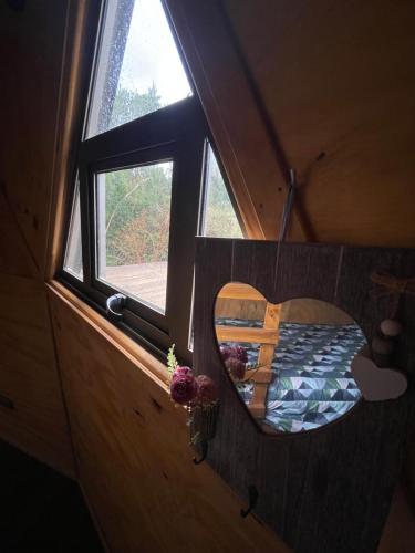 a bedroom in a tiny house with a window at Domo Tralcao Valdivia 
