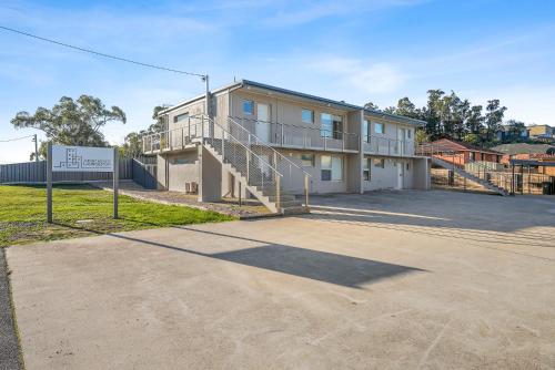 an apartment building with a sign in front of it at Apartments Launceston - Trevallyn in Launceston