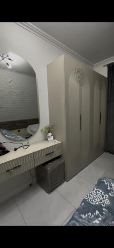 a bedroom with a desk with a mirror and a bed at A-Frame Yaşam in İsmayıllı
