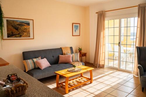a living room with a couch and a table at Stellina Mar 1 in Tarajalejo