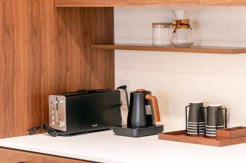 a kitchen counter with a microwave and a toaster at Takayama Showa no yado-B Modern Japanese-style villa with garden, excellent location in Takayama