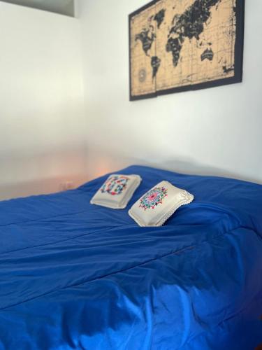 two pillows sitting on top of a blue bed at DEPARTAMENTO RINCON DE MINA in Mar del Plata