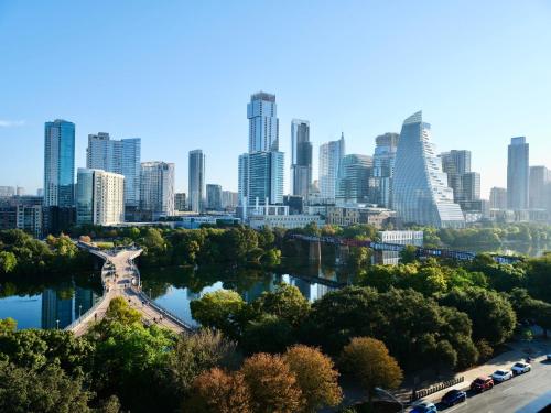 a city skyline with a bridge and a river at The Loren Hotel Austin in Austin
