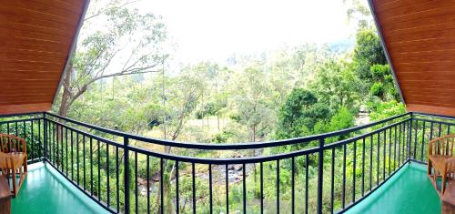 a balcony with a view of a forest at Water Side Cabin in Nallathaniya