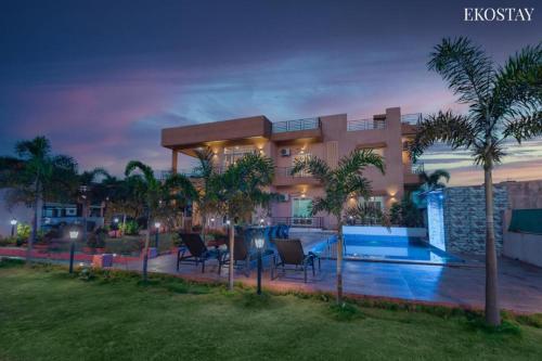 a villa with a swimming pool at night at Ultra Luxury 8 BHK Villa with a Private Pool in Lonavala in Khandala