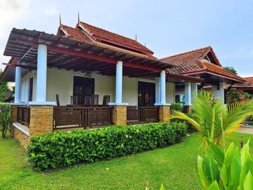 a house with a porch with blue columns at Secure 3 Bedroom Villa near beach in Kamala Beach
