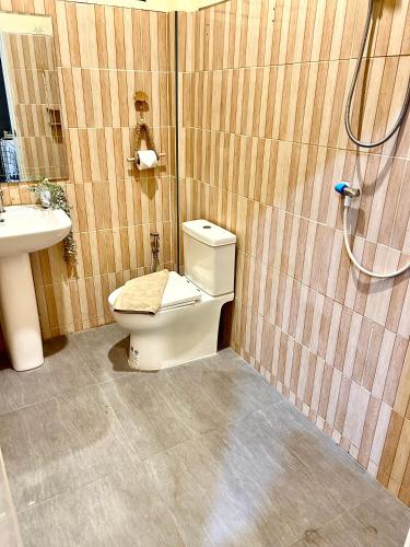 a bathroom with a toilet and a sink at Rock Reef Minimal Home in Ao Nang 