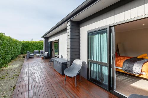 a house with a bedroom and a balcony with a bed at Forty-Five in Martinborough 