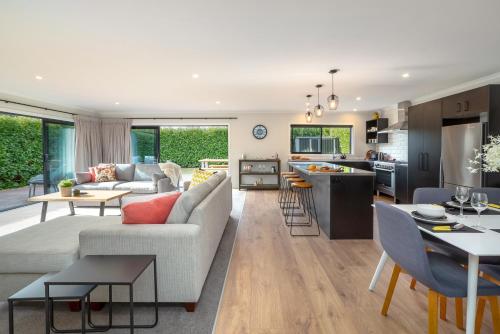 a living room and kitchen with a couch and a table at Forty-Five in Martinborough 
