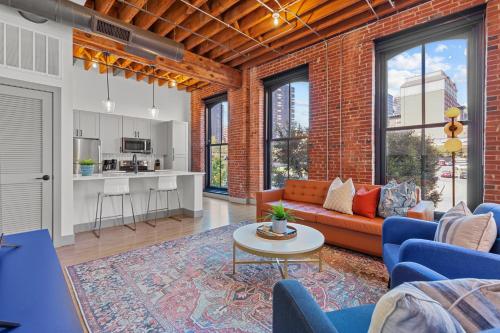a living room with a couch and a table at Brick & Bed Riverfront Lofts, G 203 in Saint Louis