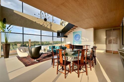 a dining room with a table and chairs at HAVN - 1 Bed at KOA Canvas, Access to Nasab Dubai in Dubai