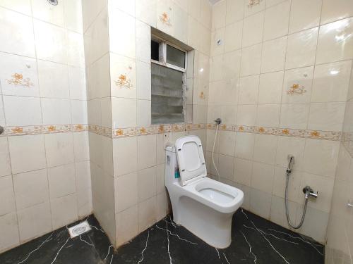 a bathroom with a toilet in a stall at Hotel Sskar Executive in Pune