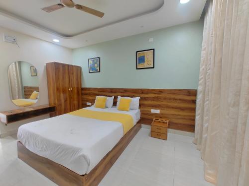 a bedroom with a bed and a ceiling fan at Hotel Sskar Executive in Pune