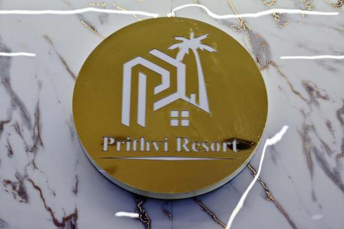 a gold sign with the name of a palmir resort at Prithvi Hotel & Resort in Gomti Nagar