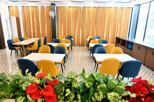 a conference room with tables and chairs and flowers at Prithvi Hotel & Resort in Gomti Nagar