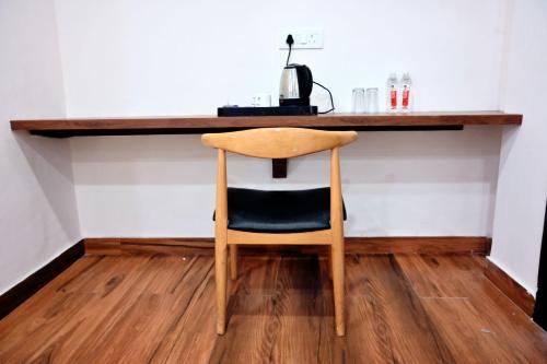 a wooden chair sitting at a counter in a room at Prithvi Hotel & Resort in Gomti Nagar