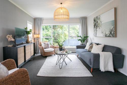 a living room with a couch and a table at Riverbreeze Retreat in Palmerston North