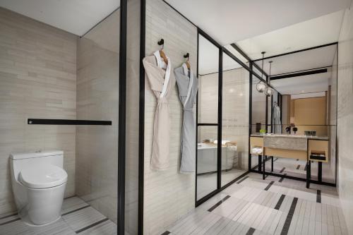 a bathroom with a toilet and a sink at Mumian Shenzhen Luohu JDV by Hyatt in Shenzhen
