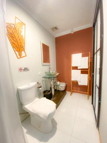 a bathroom with a toilet and a sink at Tzy-No Cottage Yogyakarta in Balong