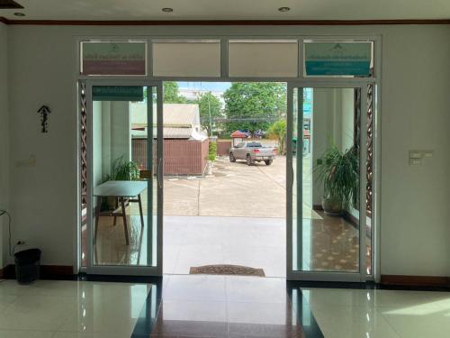 an entrance to a building with doors open to a parking lot at Rueanchorfa in Nong Bua Lamphu