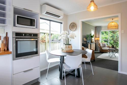 a kitchen and dining room with a table and chairs at Riverbreeze Retreat in Palmerston North
