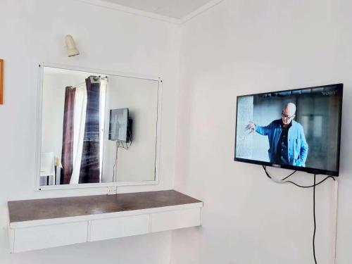 a flat screen tv hanging on a wall at Cedar Lodge Motel Hamilton in Hamilton