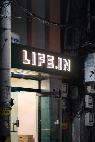 a lit up sign on the side of a building at Life in Cheonggye in Seoul