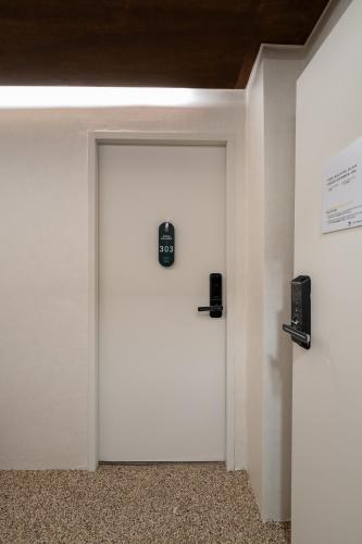 a white door with a sign on it in a room at Life in Cheonggye in Seoul