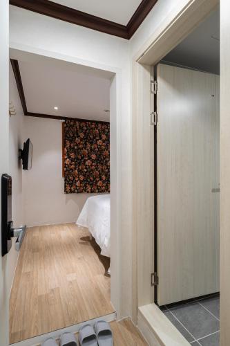 a bedroom with a bed and a wall with a painting at Life in Cheonggye in Seoul