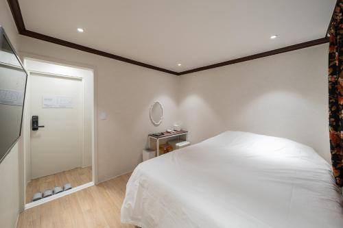 a bedroom with a bed and a walk in shower at Life in Cheonggye in Seoul