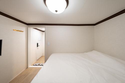 a bedroom with a large white bed in it at Life in Cheonggye in Seoul