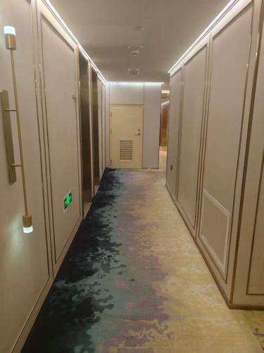 a corridor of a hallway with a long hallway at Beijing Manxin Temple of Heaven North Gate Hotel in Beijing