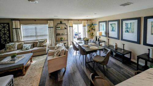 a living room with a table and a dining room at Luxury Groveland Villa with Pool, Grill & Office in Groveland