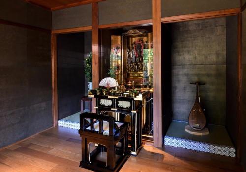 a room with a mirror and a chair and a guitar at Temple-stay WAQOO Mii-dera Vacation STAY 7051 in Otsu