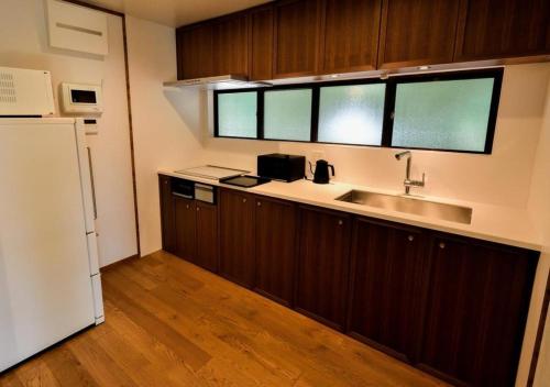 a kitchen with a sink and a refrigerator at Temple-stay WAQOO Mii-dera Vacation STAY 7053 in Otsu