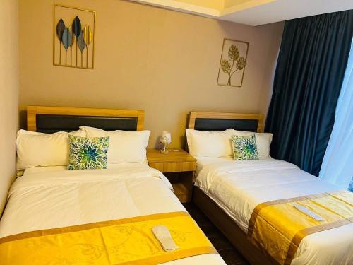 Una cama o camas en una habitación de AeonTower Suites&Hotel by CMC