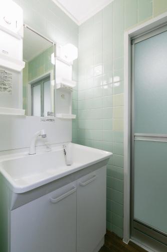 a bathroom with a sink and a mirror at Naha - House / Vacation STAY 79997 in Naha