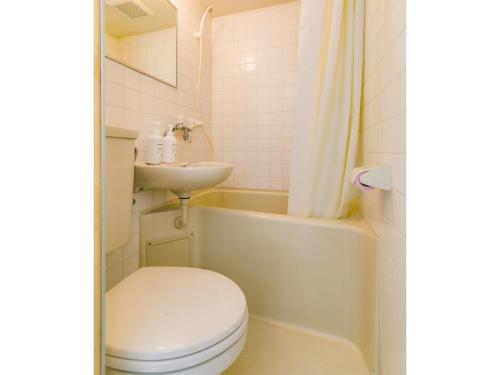 a bathroom with a toilet and a sink at Aiwa Mansion / Vacation STAY 80384 in Naha