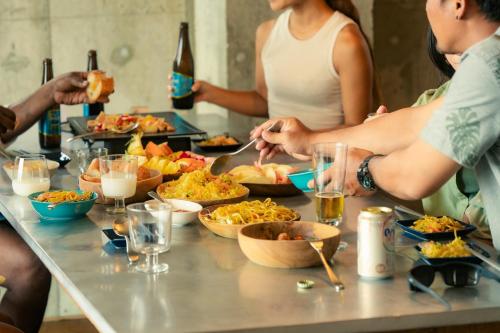 a group of people standing around a table with food at "NICE!" Ocean view of Ishigaki island, Okinawa/ Four-bedroom Villa in Ishigaki Island