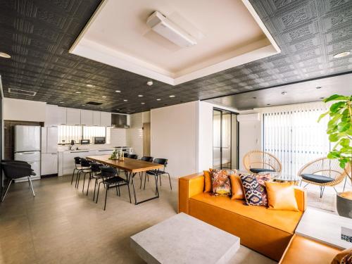 a living room with a couch and a table at 1-21-19 / Vacation STAY 80184 in Urasoe